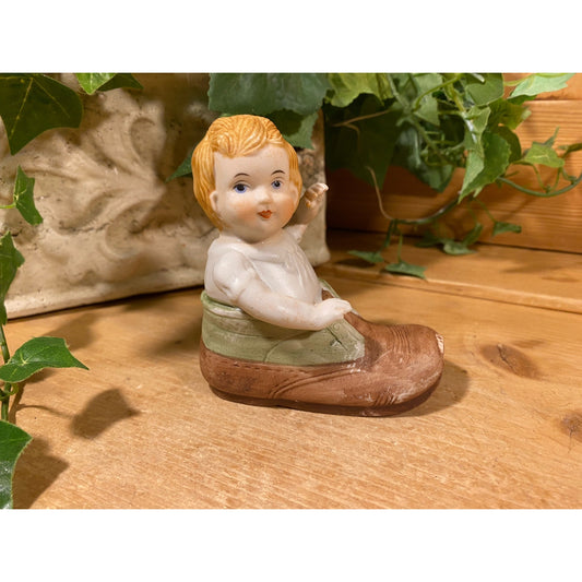 Vintage Porcelain Baby In A Shoe Figurine | Nursery Shelf Decor | Blonde Baby Boy In A Green and Brown Ceramic Shoe | Cottagecore Decor